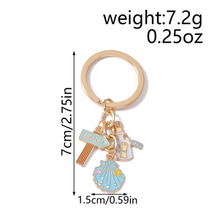 Detail shot of beach keychain with starfish and bottle charm showing 7cm size scale