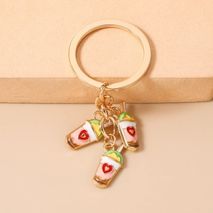Detail of colorful milk tea cup charms with red hearts on a gold-tone keychain