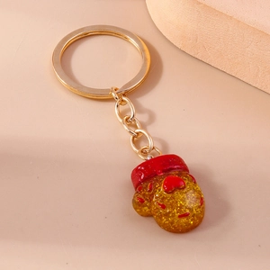 Detailed view of creative golden keychain with yellow resin pendant and red heart accent