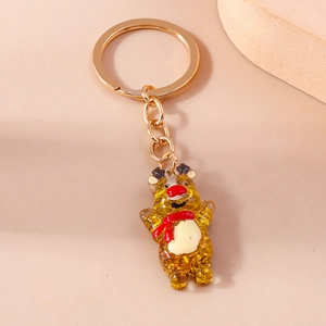 Detail of amber reindeer keychain with golden glitter and polished metal ring