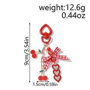 Detail view of red cherry keychain with dimensions and weight measurements