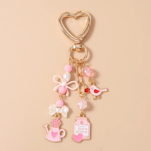 Detailed view of pink bird keychain with Be My Valentine charm and pearl beads