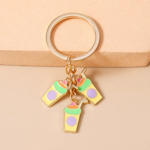 Close-up of colorful enamel beverage charms on a polished gold metal keychain ring