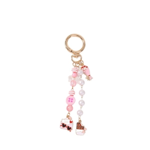 Pink and white beaded keychain with bird, flower bouquet, and golden spring ring clip