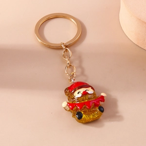 Close-up of translucent resin Christmas bear keychain with gold glitter and metal lobster clasp