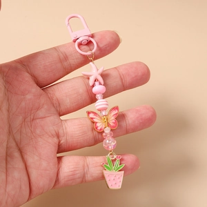Porte-clés perlé rose avec étoile de mer, papillon et fermoir homard pour sacs