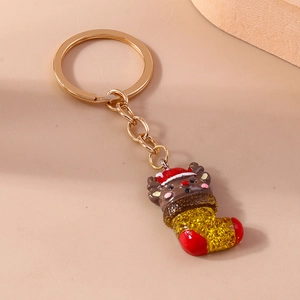 Detailed view of reindeer and sequined Christmas boot charm on a gold metal keychain