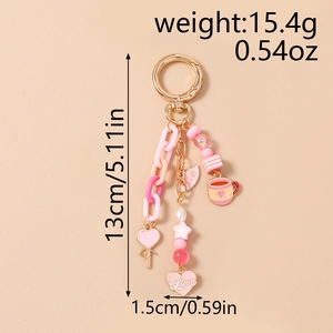 Pink beaded star keychain with Love heart pendant and striped cup charm detail