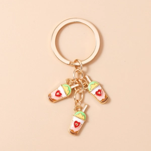 Detail view of heart-patterned bubble tea enamel pendants on a gold keychain