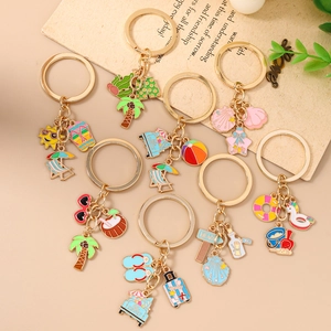 Tropical beach vacation keychain set featuring starfish and palm tree enamel charms