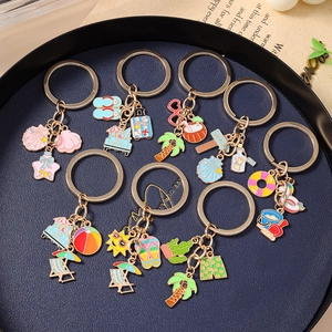 Summer beach keychain set featuring starfish, shell and palm tree charms in gold finish