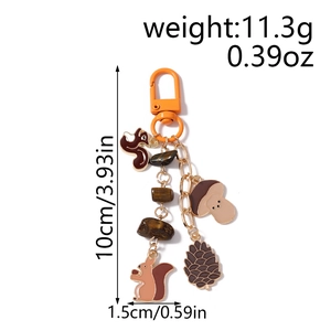 Detailed view of squirrel and pinecone charms keychain with dimension and weight labels