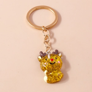 Cute Christmas reindeer keychain with gold glitter and red nose on a stylish ring