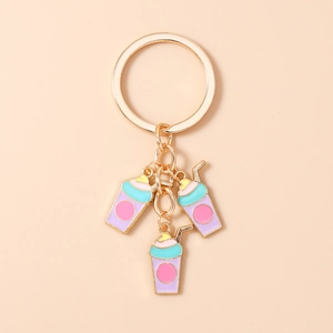 Close-up of golden metal keychain featuring colorful enamel coffee cup pendants