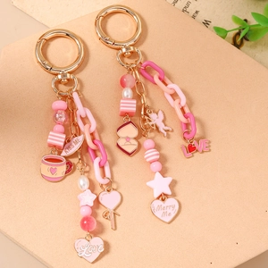 Fashionable pink beaded keychain with golden star rings and romantic love heart charms