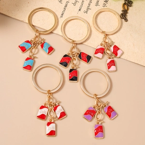 Five creative cartoon cola bottle keychains in various colors with golden metal rings