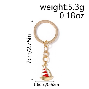 Detailed view of sailboat keychain with red white enamel and gold metal measurements