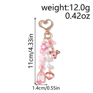 Detail view of pink beaded keychain with Be My Valentine charm and gold heart clasp