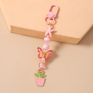 Porte-clés perlé étoile de mer rose et papillon avec breloques en émail poli