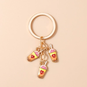 Detailed view of golden heart milk tea charms on a stylish keychain for bags