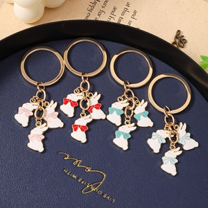 Lot de porte-clés lapin mignons avec pendentifs en émail blanc et nœuds colorés pour sacs