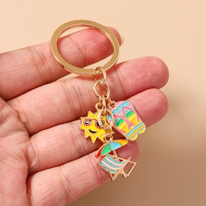 Detail of beach themed keychain with enamel sun, flip flop, and deck chair charms