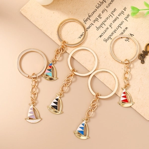 Set of 5 creative sailboat keychains with colorful enamel sails and gold metal finish
