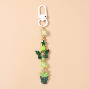 Détail du porte-clés perlé vert avec breloques cactus et papillon sur fermoir blanc