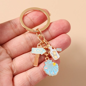 Detailed view of beach themed keychain with shell and starfish charms held by hand