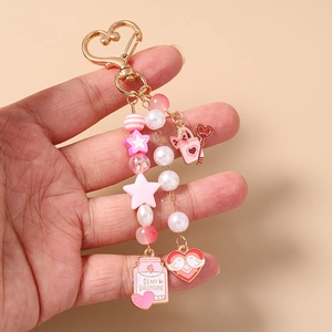 Detail of beaded Valentine's keychain with pink stars and 'BE MY VALENTINE' metal charm