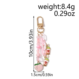 Vue détaillée du porte-clés pêche rose avec perles, chaîne et cotes de mesure
