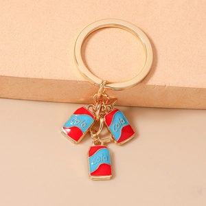 Detail of creative gold plated cola can keychain charms with red and blue enamel finish