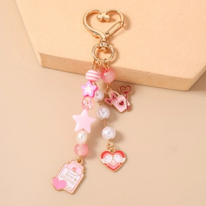 Detail of pink heart star beaded keychain with Be My Valentine heart charm and lock