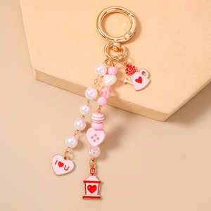 Detailed view of pink beaded keychain with I Heart U charms and pearl accents