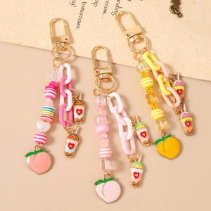 Porte-clés mignon pêche et thé au lait avec fermoir doré et perles en résine colorée