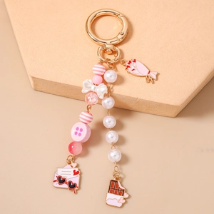 Detailed shot of pink beaded star keychain with heart envelope and chocolate charms