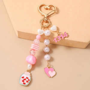 Detailed shot of pink heart keychain with 1314 numeric charms and acrylic beads