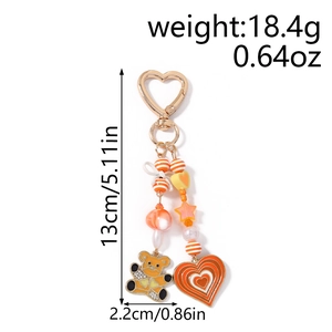 Detailed view of orange beaded keychain with bear charm, showing 13cm height and 2.2cm width