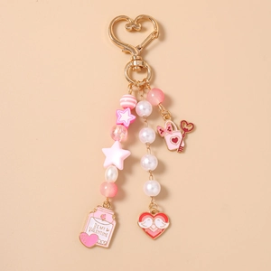 Detail of pink star beads and Be My Valentine heart pendant on a gold keychain