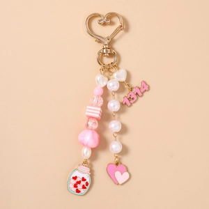 Detail view of pink beaded keychain with 1314 pendant and heart-shaped spring clasp