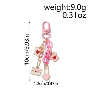 Pink heart keychain charm with thick acrylic chain and envelope pendant details