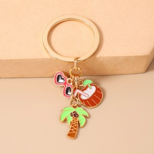 Detail of beach keychain with coconut tree, drink, and heart sunglasses charms