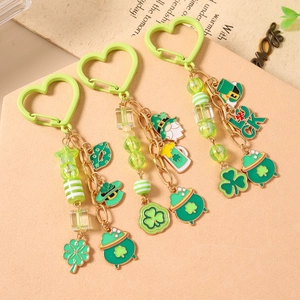 Three St. Patrick's Day beaded keychains with green clover charms and lucky hat pendants