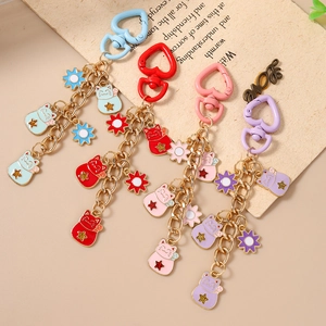 Colorful Maneki Neko lucky cat keychains with heart hooks and floral charms in four colors