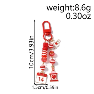 Detail view of Valentine's keychain with red beads, Love tag and February 14 calendar charm