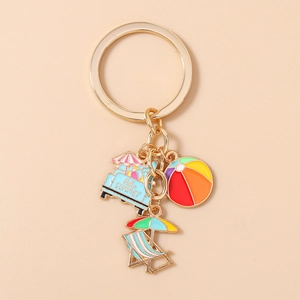Detail of summer beach keychain with starfish, coconut tree and colorful charms