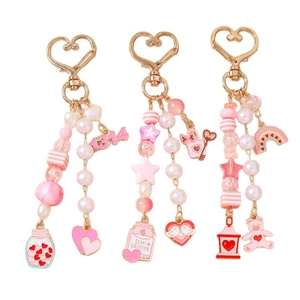 Pink beaded bear and heart keychain set with rainbow charms and 1314 star pendants