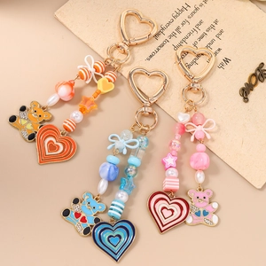 Beaded heart bear keychains in orange, blue, and pink with bow charms and star beads