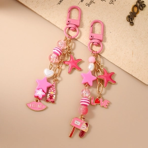 Pink beaded keychain with starfish, star, and kiss lips charms for handbags