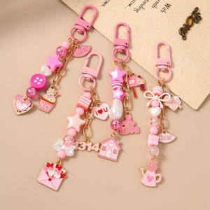 Rosa Schlüsselanhänger-Set mit Herz Haus und Gießkanne Anhängern für Handtaschen